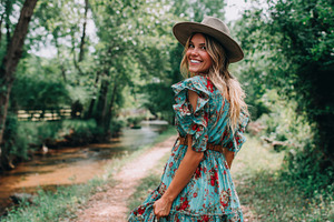 Woman in floral dress enjoys nature, a Photo by Beautiful things