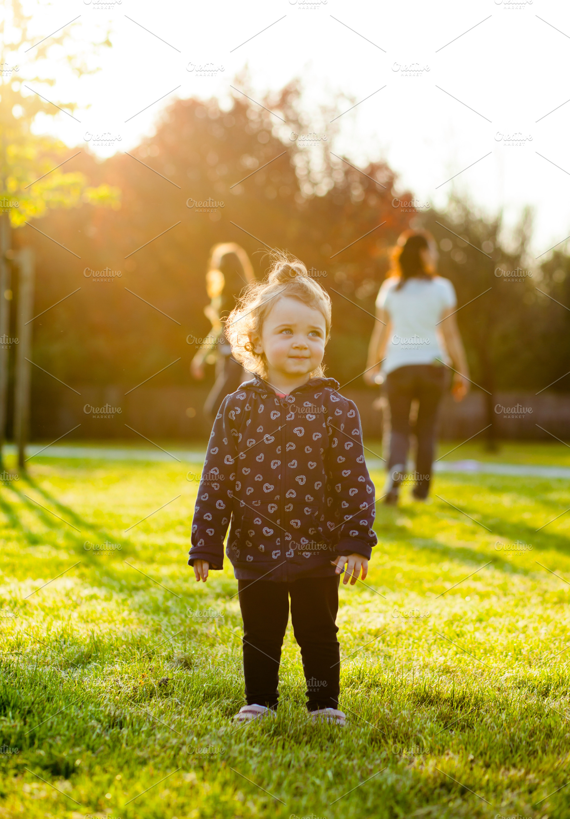 Little baby girl plays in the park stock photo containing people and portrait, a Person Photo by Antonio Gravante Market
