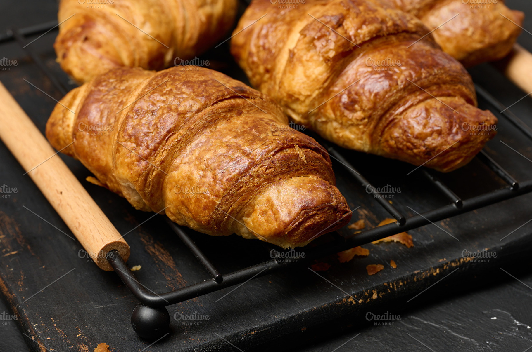 Freshly baked croissants on a black table, delicious breakfast, a Food & Drink Photo by ndanko