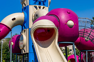 Brightly colored playground with space rocket design, featuring a large slide a, a Sports & Recreation Photo by Ales Munt