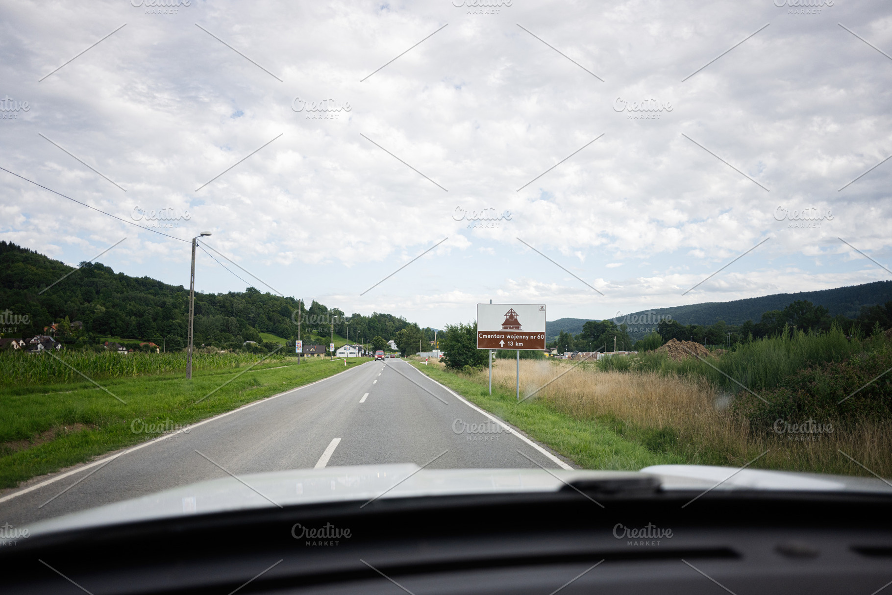 Countryside road passing through Poland, with scenic views and clear skies. Cme, a Photo by AS photostudio