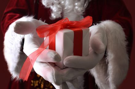 Detail of Santa Claus offering a gift in his hands., a Holiday Photo by Davizro's Market