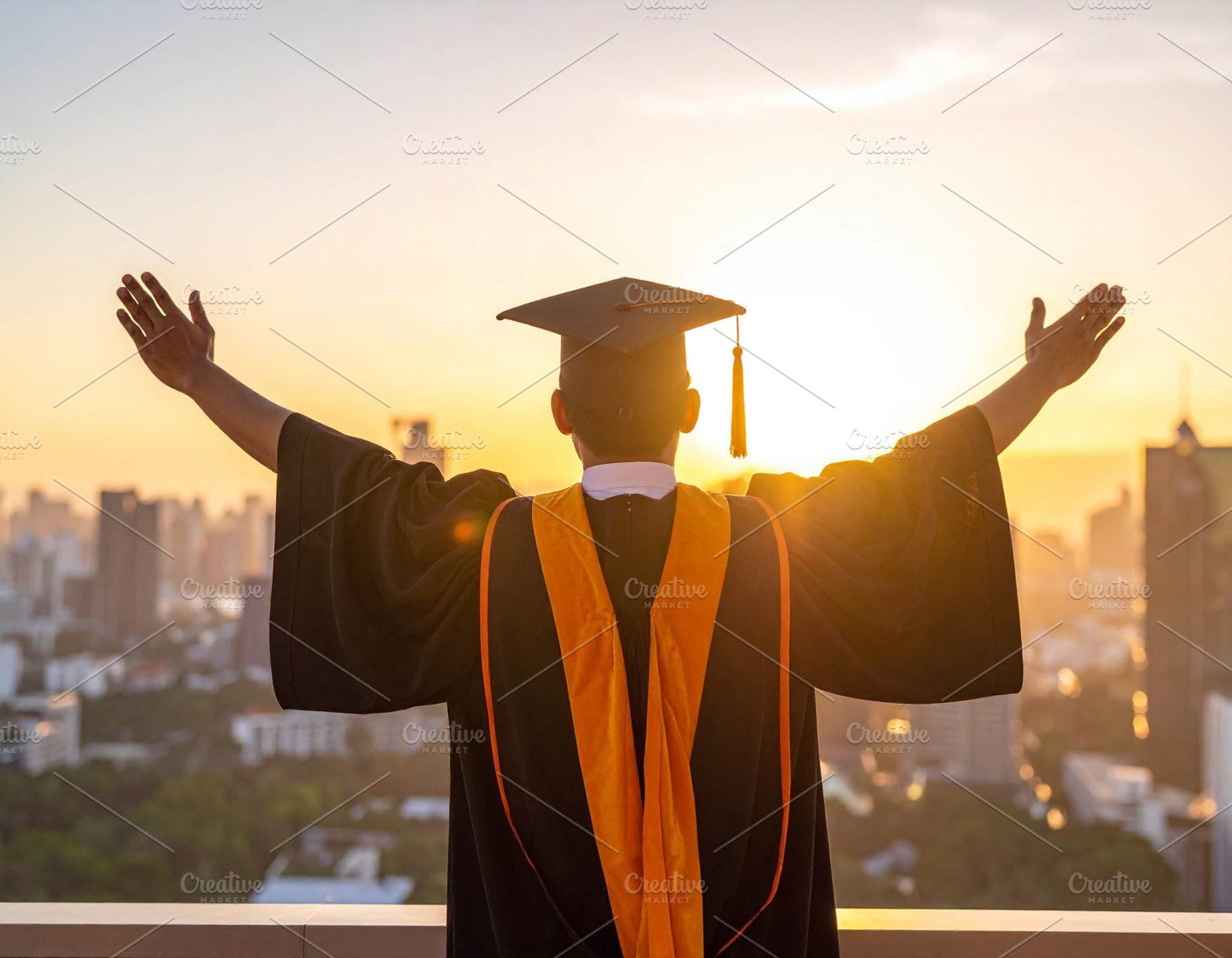 Student in graduation gown standing at the edge of a rooftop ove, a School & Education Photo by DanFLCreativo