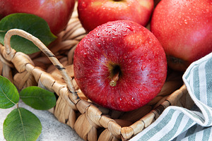 Fresh red apples resting in a basket, a symbol of healthy eating, a Food & Drink Photo by Olena Rudo