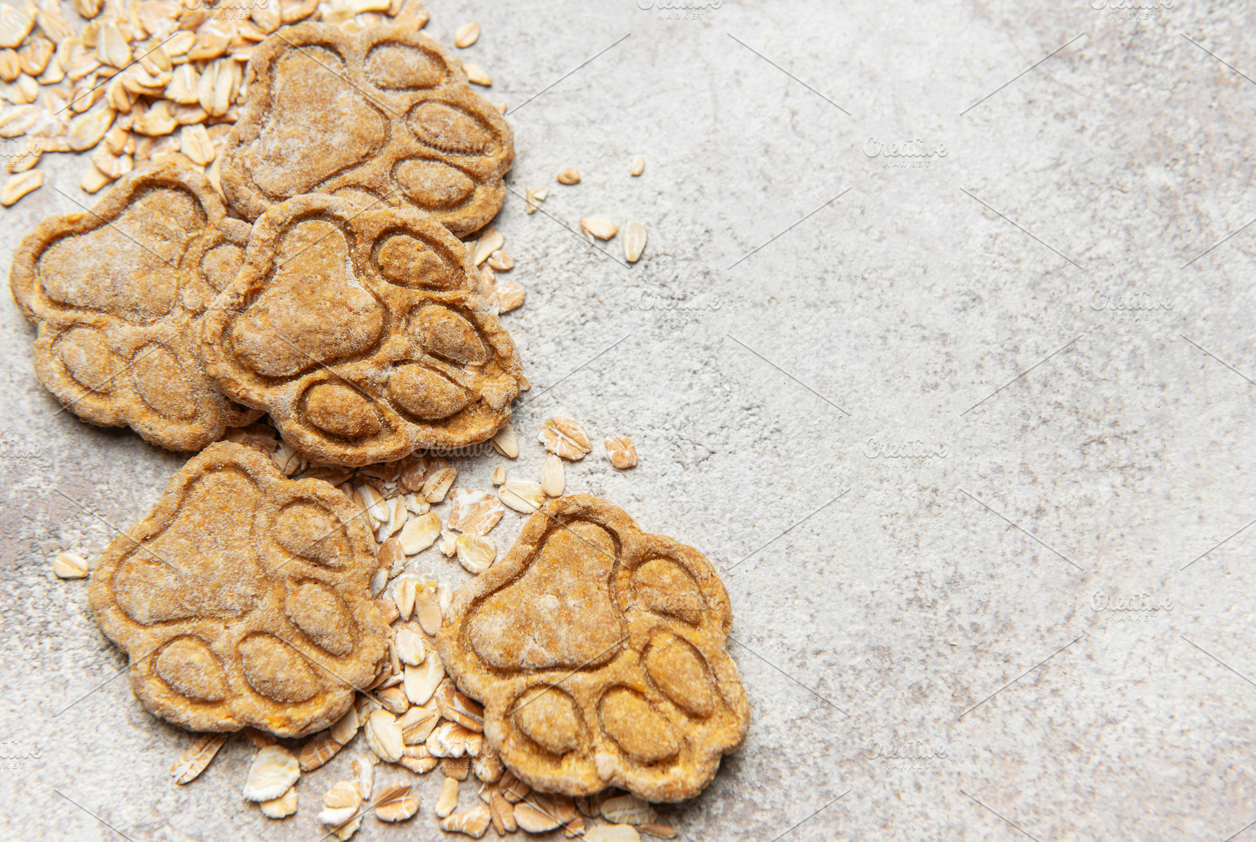 Homemade oat dog treats shaped as paw prints, a Food & Drink Photo by Olena Rudo