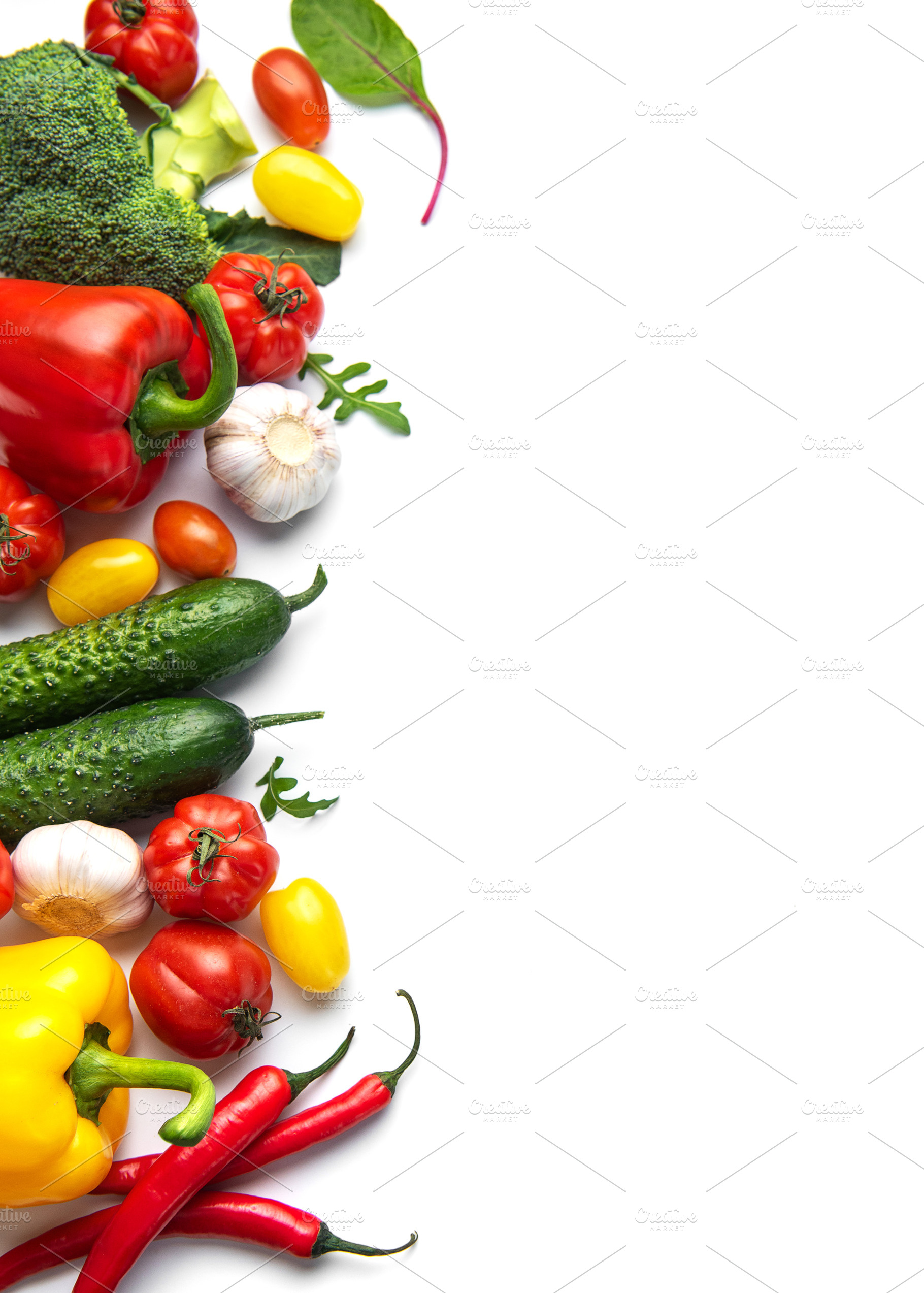 Fresh organic vegetables and spices creating a border, a Food & Drink Photo by Olena Rudo