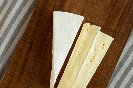 Organic Homemade White Brie Cheese on a Wooden Board, top view., a Food & Drink Photo by LiudmylaChuhunova
