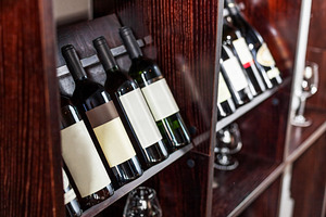 Bottles of wine displayed on the win, a Food & Drink Photo by Volff