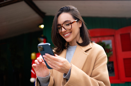 Woman using smartphone looking screen and smile, a Person Photo by andreonegin market