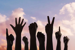 Group of raised hands protest gesture against sky, freedom expre, a Photo by salmon.black