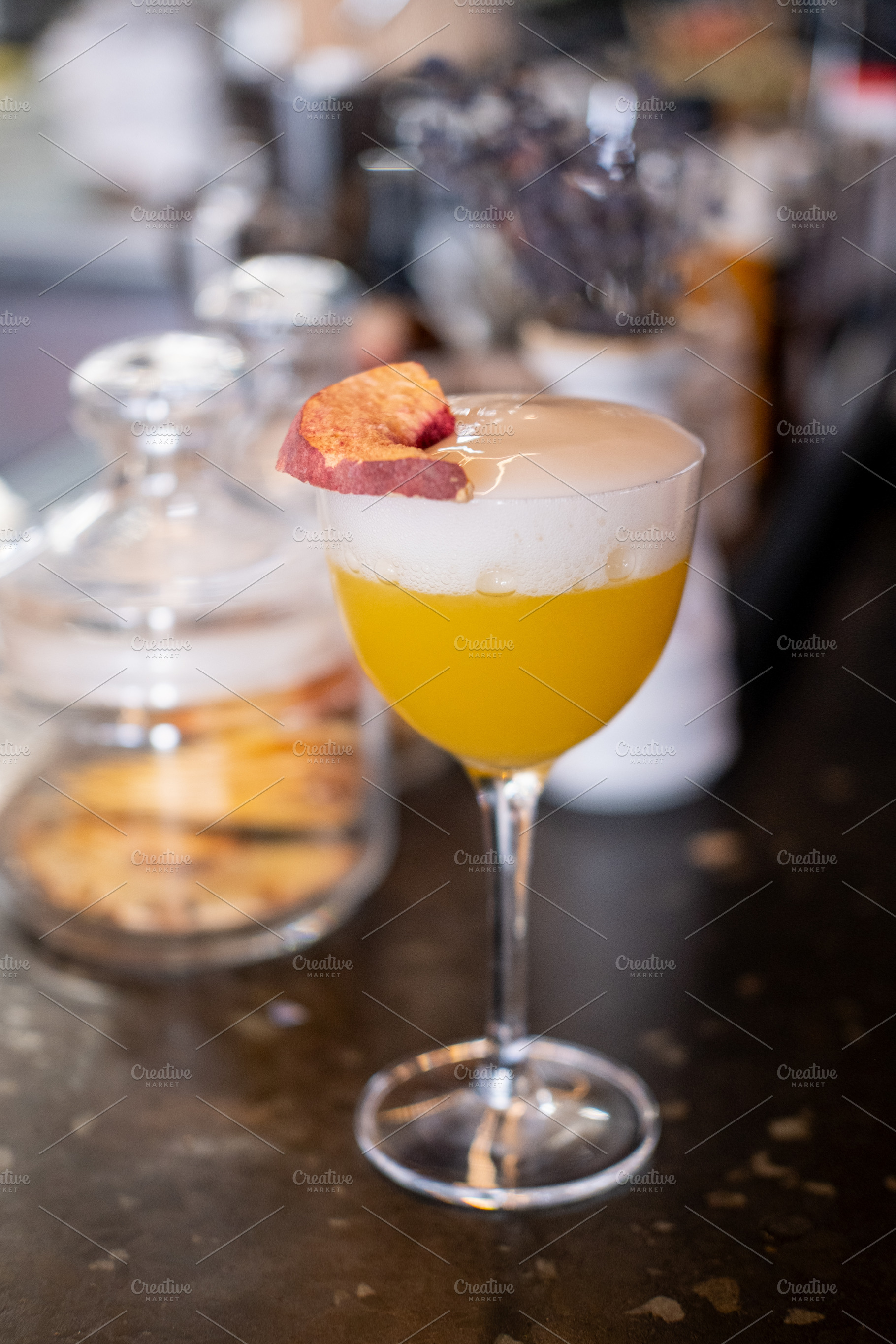 Served cocktail bright beverage frothy glass peach, a Food & Drink Photo by Photo Drive Studio