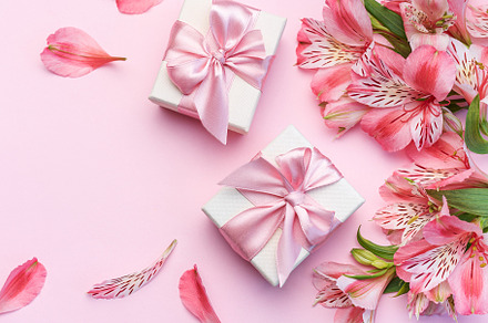 Beautiful Alstroemeria flowers and gift boxes on pink background, a Holiday Photo by Olena Rudo
