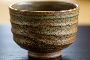 Handmade ceramic tea bowl with earth, a Food & Drink Photo by professorinc