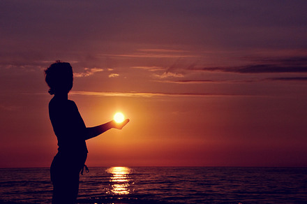 Silhouette holding sun, a Person Photo by BOOCYS