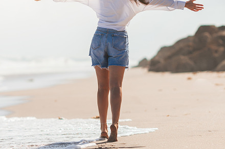 Young happy woman on the beach, a Person Photo by travnikovstudio