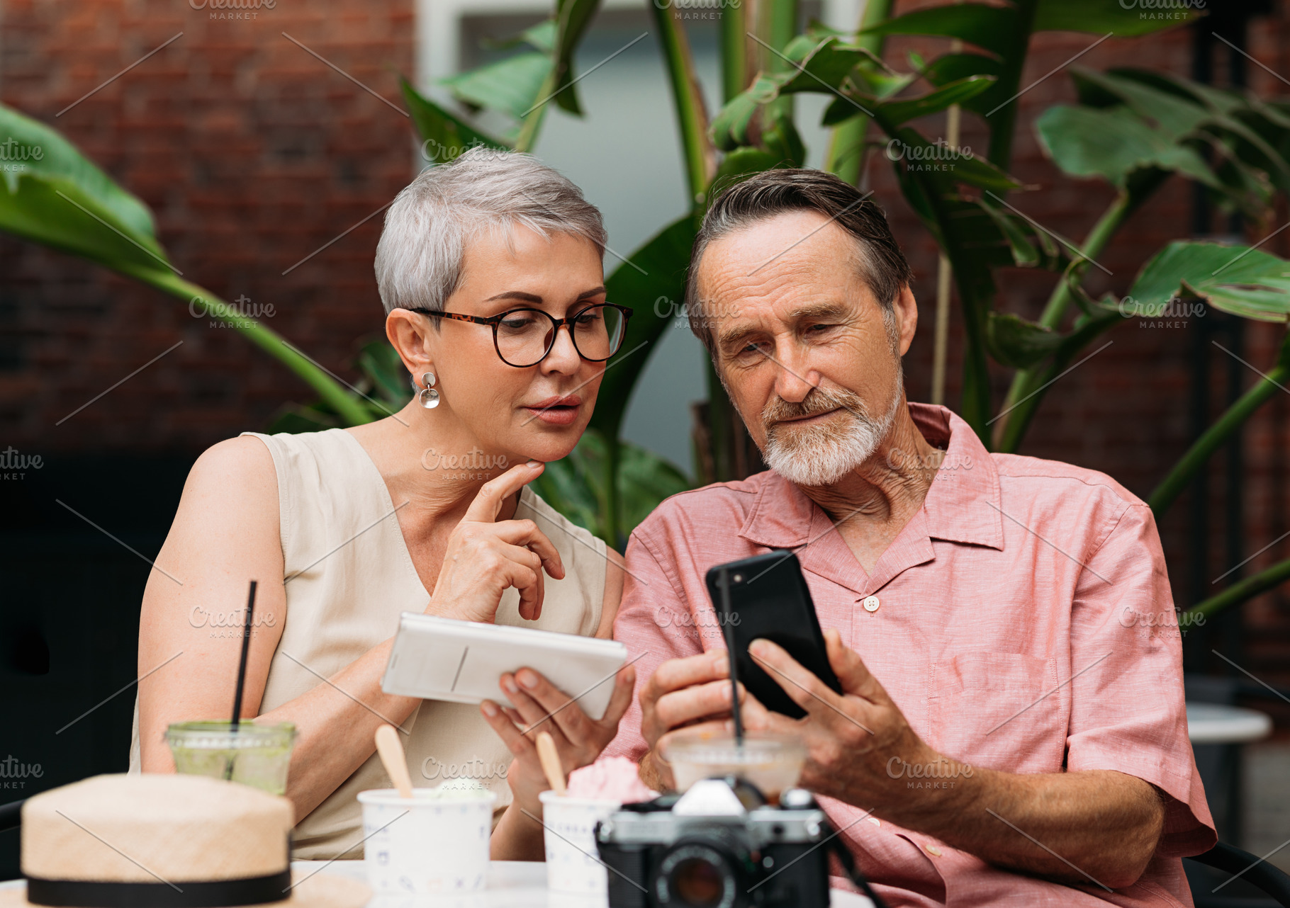 Mature couple using their smartphone, a Person Photo by Artem Varnitsin