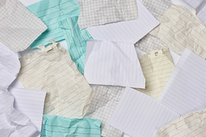Messy pile of crumpled and torn multicolored grid and lined pape, a Business Photo by ndanko