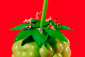 miniature holidaymakers on a fruit bottle, a Photo by Nito