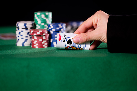 Close-up of hands with pair of kings