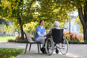 Sad elderly woman in wheelchair