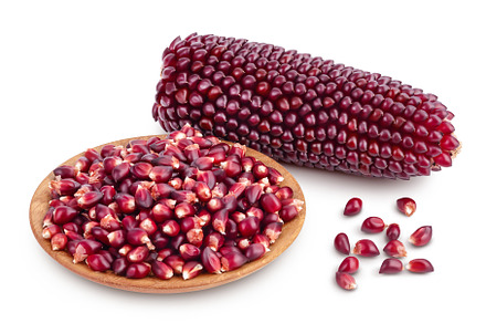 Purple corn seeds in wooden bowl, a Food & Drink Photo by NataPhoto
