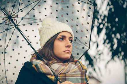 Young girl holding umbrella in an au containing winter, woman, and blue monday, a Person Photo by davidpereiras