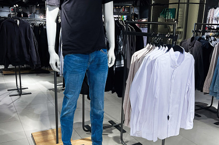 Modern clothing store with mannequin wearing casual clothing on display, a Photo by AS photostudio