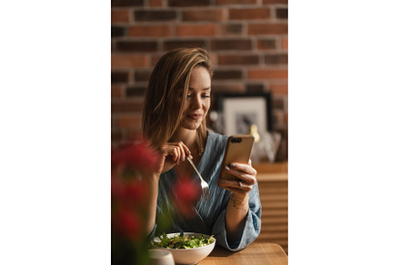 Young woman eating salad and, a Food & Drink Photo by HalfPoint