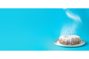 Icing sugar falling on bundt cake, a Food & Drink Photo by Fascinadora