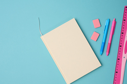 notebook and pink ruler on blue background, top view, a School & Education Photo by ndanko