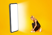 Athletic Woman Lacing Shoes Near Big Smartphone Screen, Yellow Background, a Photo by Prostock-Studio (Thumbnail 3 of 3)
