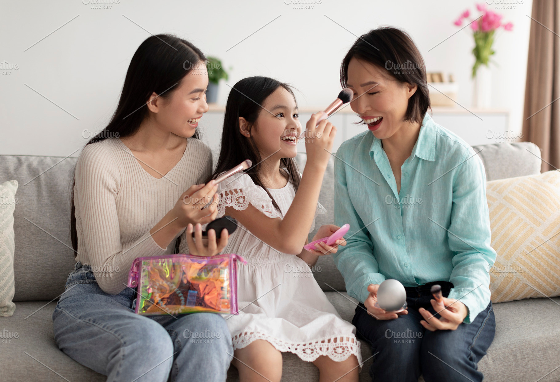 Makeup spa day concept. Adorable little girl Asian with mother and granny apply, a Photo by Prostock-Studio