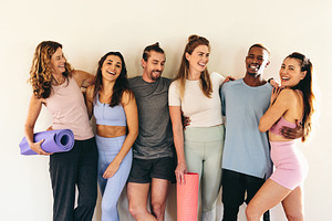 People standing as a group in a yoga studio, a Person Photo by Jacob Lund