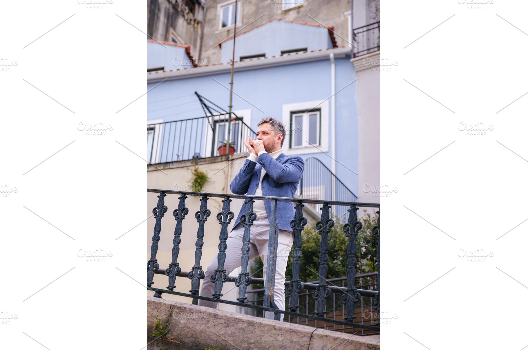Man plays harmonica outdoors in city, a Person Photo by f9photos
