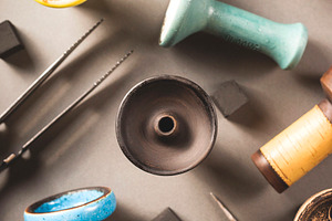 Many different ceramic color bowls containing hookah, tobacco, and shisha