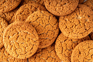 Homemade classic Gingersnap Cookies stack on kitchen table, a Photo by Rimma