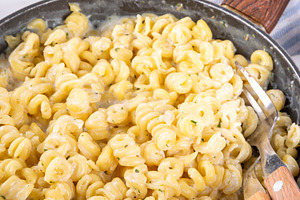 Fusilli bucati pasta with cheesy creamy sauce, a Food & Drink Photo by Rimma