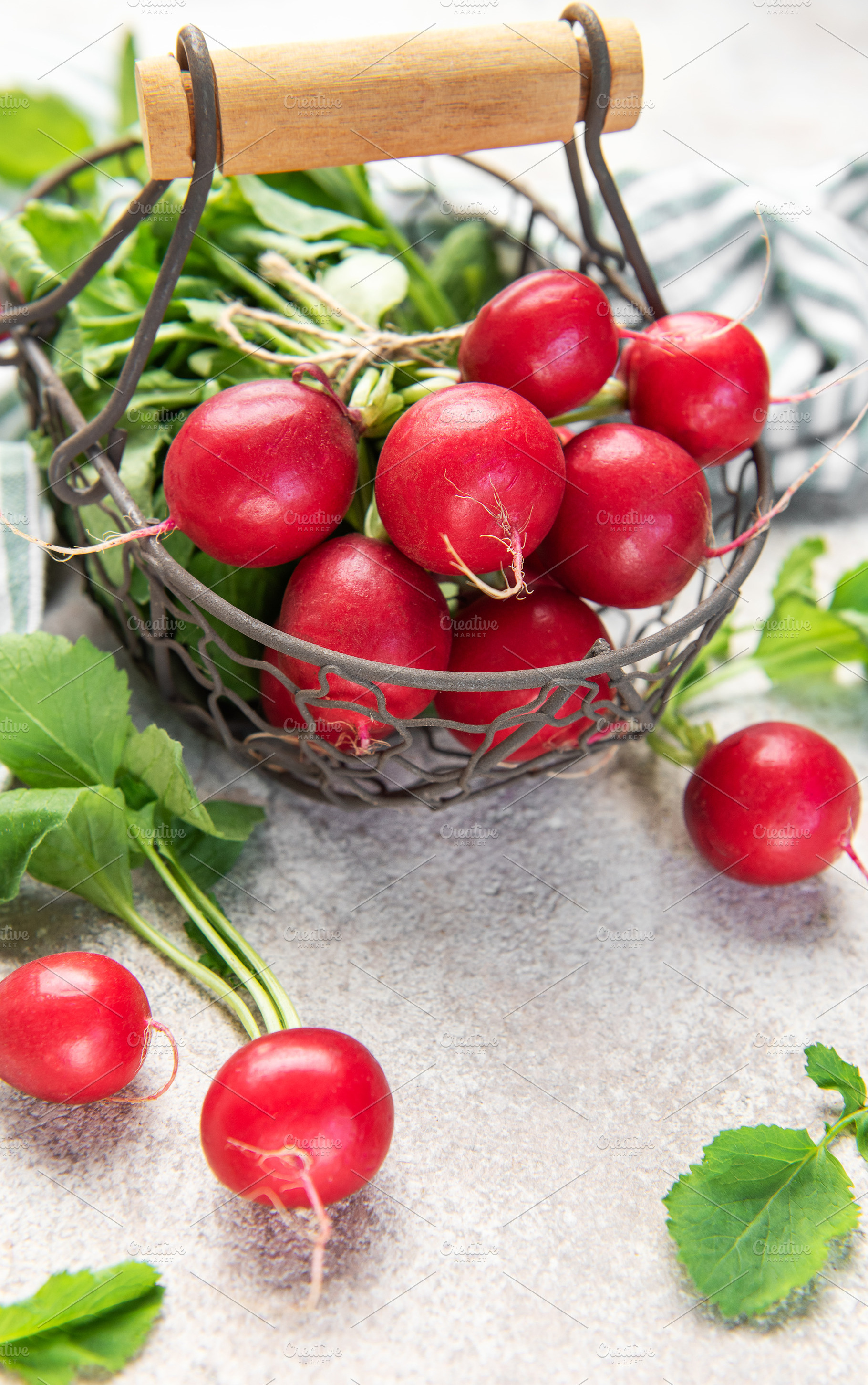Fresh red radishes in a basket on a concrete surface, a Food & Drink Photo by Olena Rudo