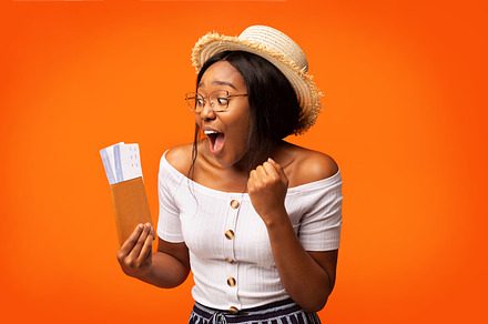 Excited Black Woman Holding Tickets And Passport Standing, Orange Background, a Person Photo by Prostock-Studio