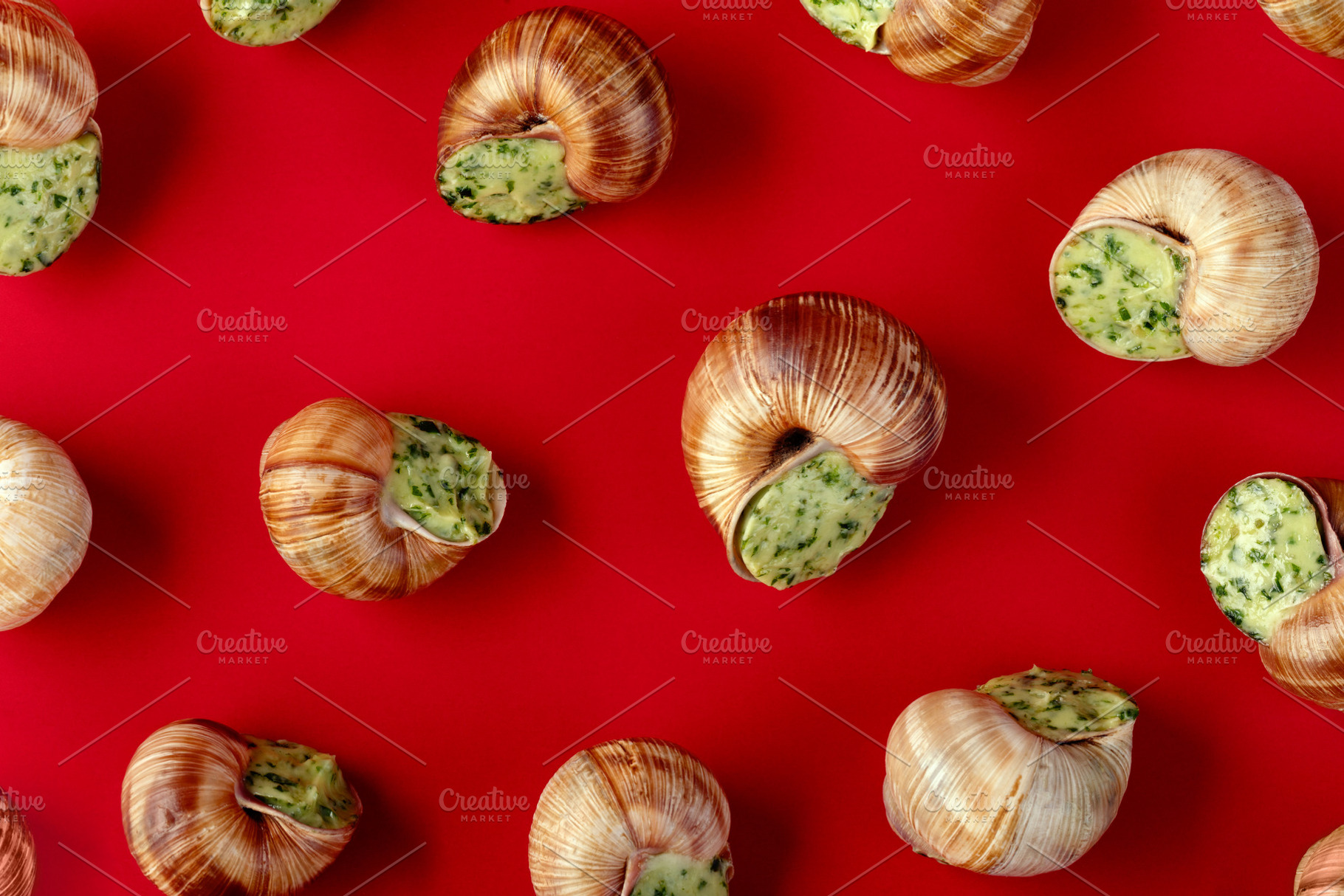 Gourmet escargot stuffed with garlic herb butter arranged on a v, a Food & Drink Photo by Ales Munt
