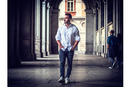 Young man in European city street, a Person Photo by ArtOfPhotos photo store