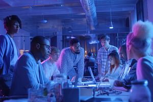 A diverse group of professionals engaged in a collaborative meeting in a modern, a Person Photo by Textures & Backgrounds