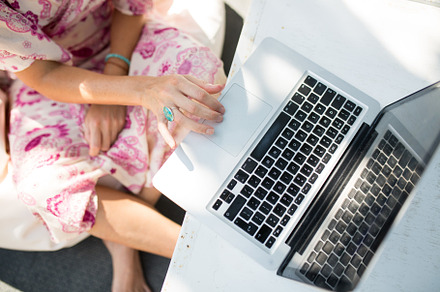 woman typing on her laptop outdoors