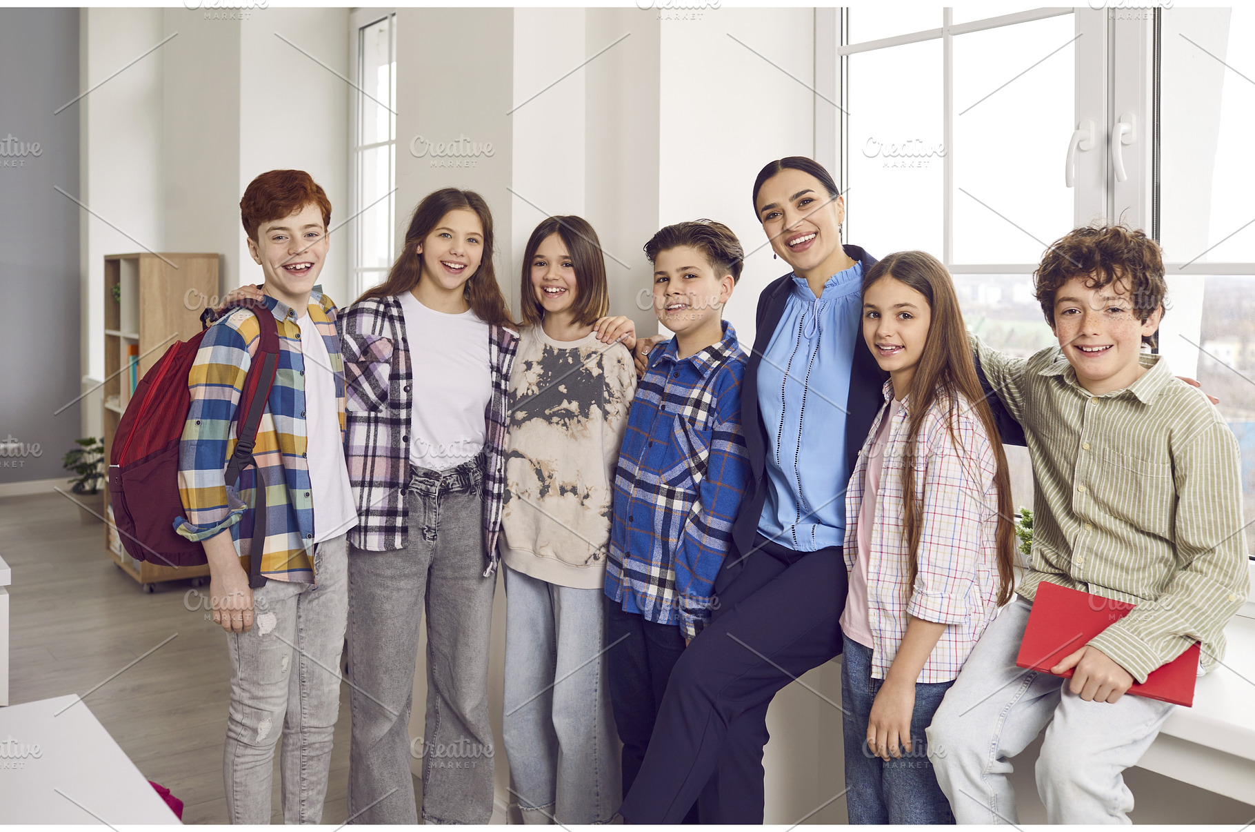 Happy school students standing close, a School & Education Photo by StudioRomantic