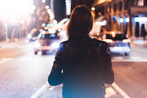 Girl in the city on a night street featuring concept, back, and black