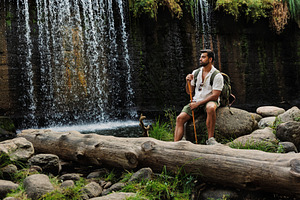 Hiker resting on a rock next to a wa, a Person Photo by Perpis