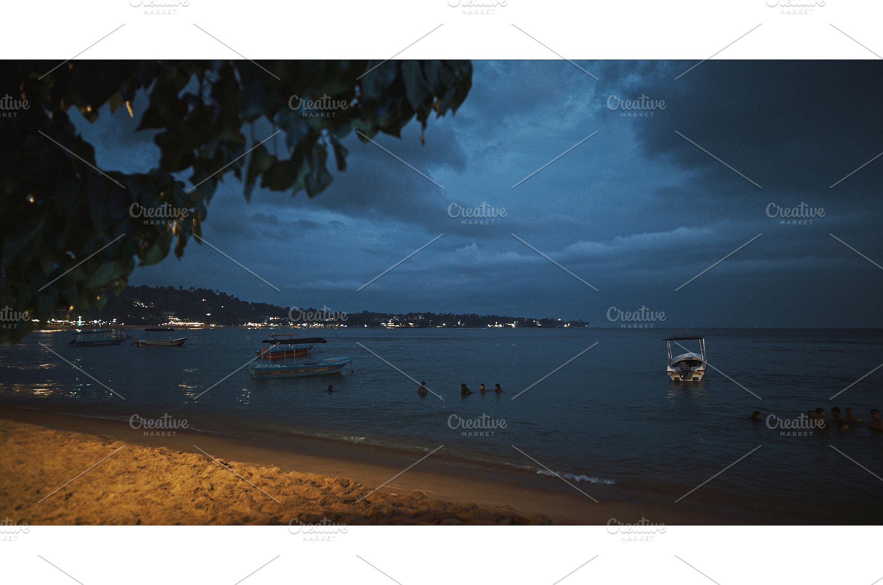 Calm beach at night with boats and, a Nature Photo by Our Amazing World