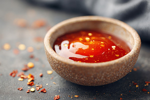 Bowl of spicy sauce with red pepper flakes, a Food & Drink Photo by AlyaAnd