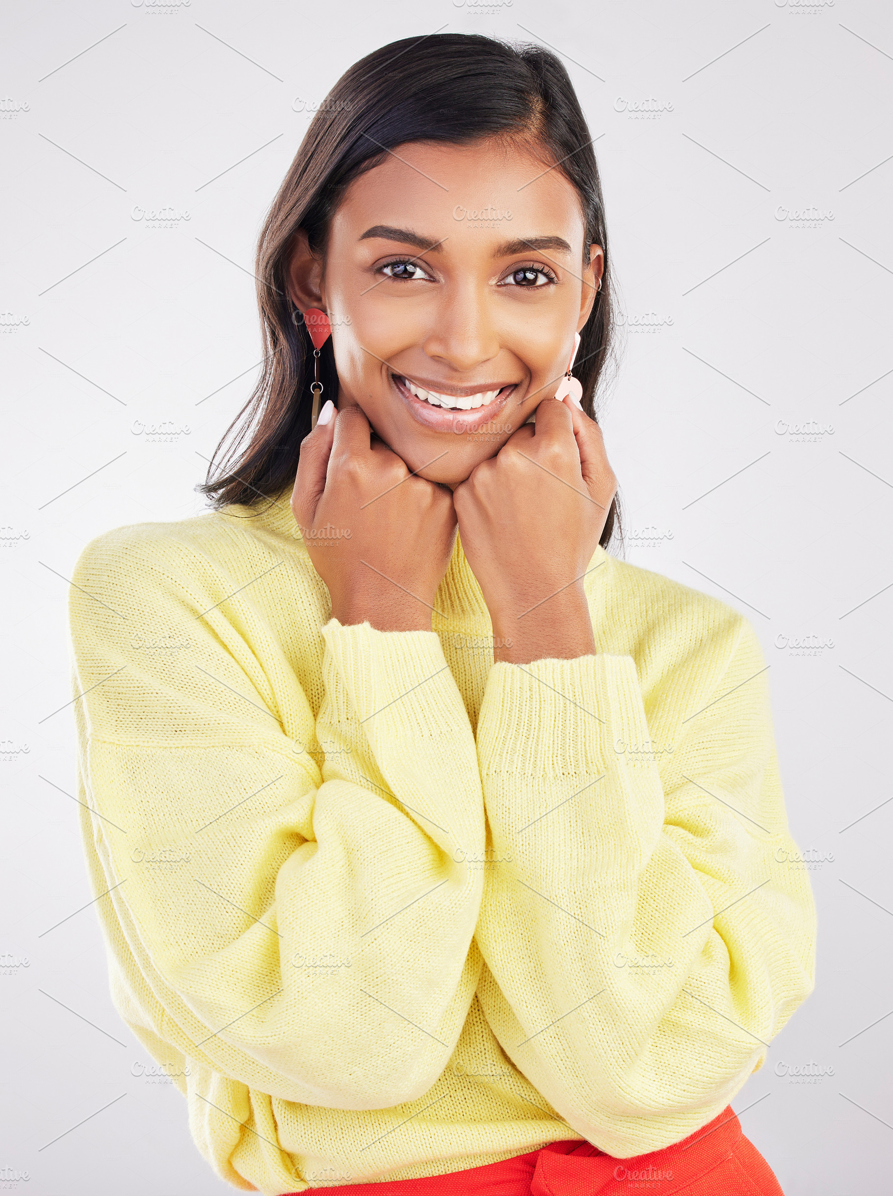 Happy, smile and portrait of a woman in a studio with a casual outfit and positive mindset. Happiness, excited and face of a stylish Indian female model with fashion isolated by a gray background., a Photo by Peopleimages.com