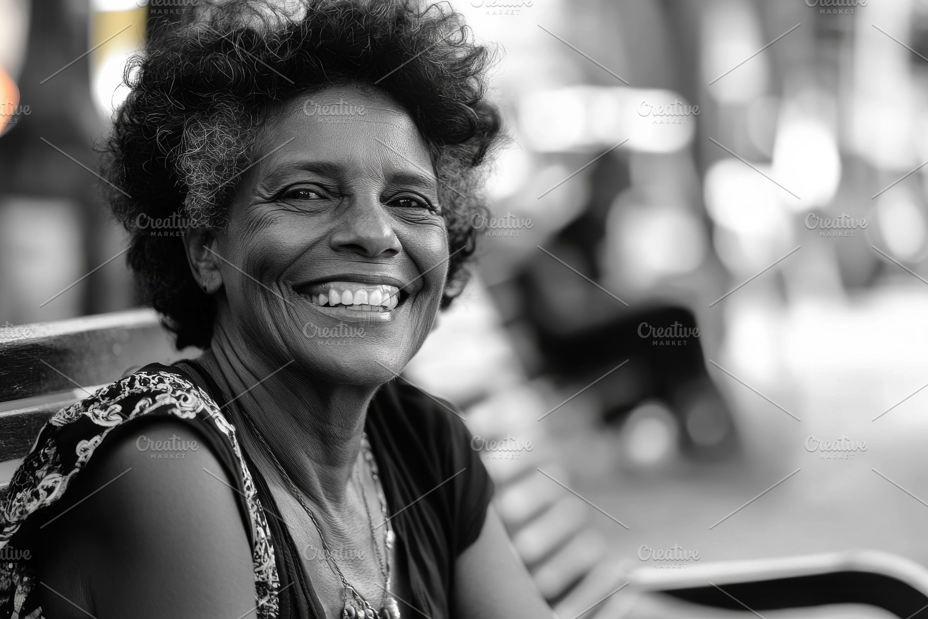 Smiling black woman sitting on a par, a Photo by Iftikhar Alam